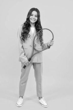 Fashion and sport concept. Teenager child with tennis racquet. Kids fitness