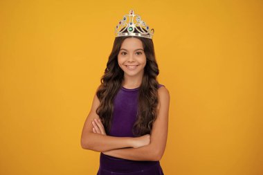 Girls party, funny kid in crown. Child queen wear diadem tiara. Cute little princess portrait. Happy girl face, positive and smiling emotions