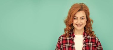 Woman isolated face portrait, banner with mock up copyspace. happy redhead woman in checkered shirt. express positive emotions. smiling lady with curly hair