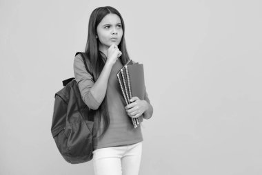 School teenager child 12, 13, 14 years old with book and copybook. Teenager schoolgirl on isolated background. Thinking face, thoughtful emotions of teenager girl clipart