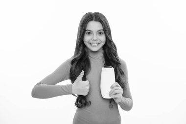 Teenager child girl with bottle shampoo conditioners or shower gel. Kids hair care. Hair cosmetic product, shampoo bottle. Happy girl face, positive and smiling emotions