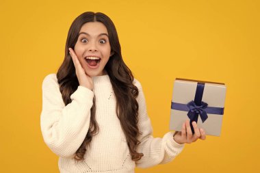 Cute teenager child girl congratulate with valentines day, giving romantic gift box. Present, greeting and gifting concept. Surprised teenager girl