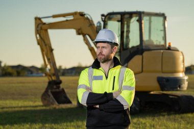 Builder in helmet on the construction site
