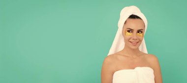Woman isolated face portrait, banner with copy space. happy young woman in shower towel with golden patch
