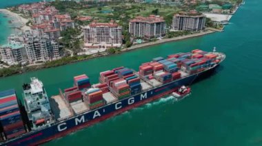 Miami, Florida, ABD - 23 Haziran 2024 Miami 'de kargo gemisi, hava manzaralı. Kargo gemisindeki nakliye konteynırı Fisher Adası 'nı geçiyor. Kargo gemisi limana giriyor. Konteyner gemisi.