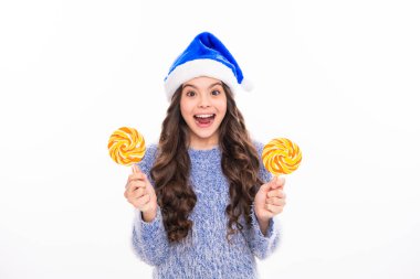 Teen girl in christmas winter sweater on white isolated background. Winter teen girl hold christmas lollipop clipart