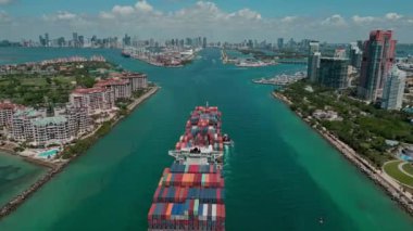 Miami, Florida, ABD - 23 Haziran 2024: kargo gemisiyle Fisher Adası 'nı geçiyoruz. Kargo gemisi. Konteyner gemisi. Miami 'de konteynırlı kargo gemisi, hava manzaralı. Nakliye endüstrisi.