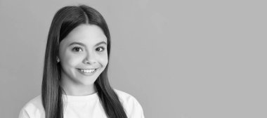 happy child with long hair on blue background. Child face, horizontal poster, teenager girl isolated portrait, banner with copy space
