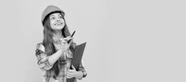 childhood development. happy labour day. future career. teen girl in helmet making notes. Child in hard hat horizontal poster design. Banner header, copy space