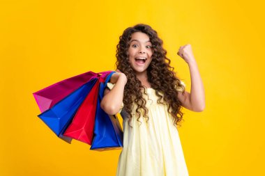 Komik genç kız alışveriş torbasını sarıda tek başına indirimden zevk alıyor. Genç bir kızın portresi alışverişe gitmeye hazır. Heyecanlı bir genç, şaşkın ve neşeli duygular içinde