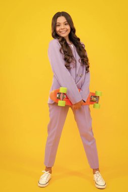 Teen hipster girl skater with skateboard on isolated background. Summer kids trend, urban teenage style