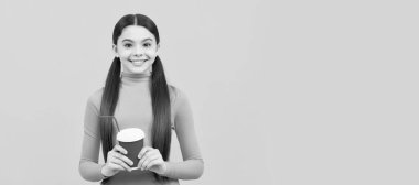 happy child with takeaway coffee cup on yellow background, morning. Horizontal poster of isolated child face, banner header, copy space