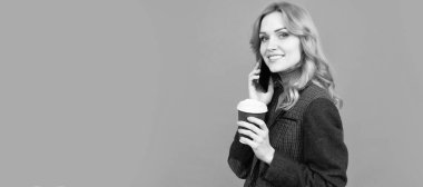 Enhanced coffee for enhanced lifestyle. Woman hold disposable cup talking on phone. Modern lifestyle. Woman portrait, isolated header banner with copy space