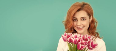 happy woman with tulip flower bouquet on blue background. march 8. Woman isolated face portrait, banner with mock up copyspace