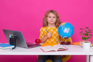 Kid boy from elementary school with book. Smart caucasian school boy kid pupil going to school. School child isolated on red pink studio background. Concept of education and learning