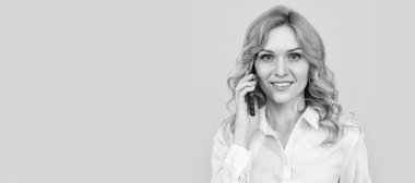 Kahve fincanı olan neşeli sarışın kadın sarı arka planda telefonla konuşuyor. İzole edilmiş yüz portresi, taklit alanı olan pankart
