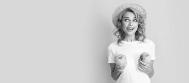 Summer girl hold apple. cheerful redhead woman in straw hat hold apple licking lips, dietary. Woman isolated face portrait, banner with mock up copy space