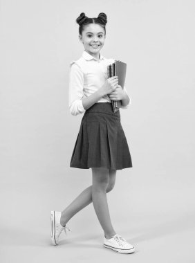 Teenage school girl with books. Schoolgirl student. Happy teenager, positive and smiling emotions of teen girl