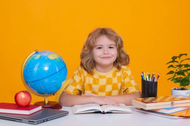 School and education concept. Portrait of cute child school boy, isolated on yellow background. Back to school