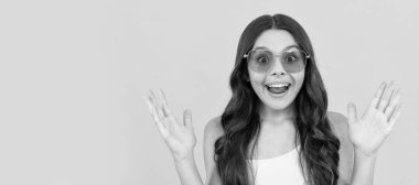 happy funny kid in eyeglasses. cool teen girl having fun in glasses. amazed child. Child face, horizontal poster, teenager girl isolated portrait, banner with copy space