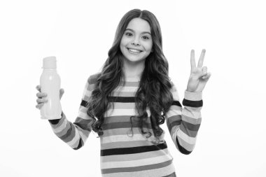 Teen holds water bottle isoalted on white. Child girl care body hydration. Active leisure and water balance. Active and healthy kid drink water. Happy girl face, positive and smiling emotions