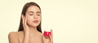 Beauty woman skin. Woman beauty face, close up portrait, isolated banner with copy space. young girl hold hair mask. lady with skin cream. daily habit and personal care