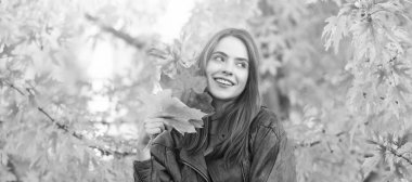 Autumn fall woman banner with copy space. happy girl with school bag near autumn colorful leaves on rowanberry tree, nature