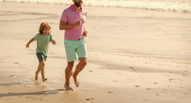 cropped father and son running on summer beach, copy space, summer.