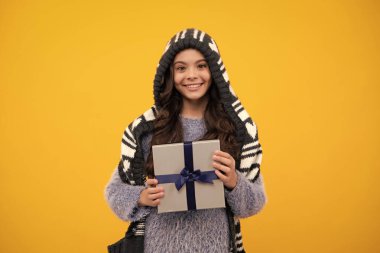Teenager child with gift box. Present for holidays. Happy birthday, Valentines day, New Year or Christmas. Kid hold present box. Happy teenage girl, positive and smiling emotions