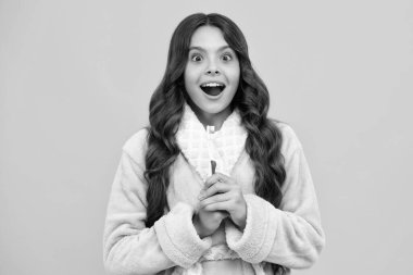 Night brushing teeth. Girl cleaning teeth. Kid brushing teeth with brush. Dental hygiene, tooth care. Girl cares about health of his teeth. Excited expression, cheerful and glad