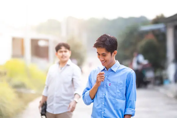 stock image Cheated by his business partner. A guy does something sneaky and underhanded behind his own friend's back. Guy Smiling wickedly to plan something deceptive