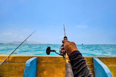 Balıkçı Eli Denizde Olta Tutuyor. Geniş Mavi Sularda Teknede Solo Balıkçı.
