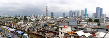 Shantytown, slum area, crowded residential area in Jakarta clipart