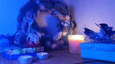 Yeni yıl aksesuarları, Noel Baba heykelciği, parlak renkli çelenk, mavi şerit. Noel çelenkleri el yapımı atmosfer şenlikli bir akşam, yeni yıl arifesi natürmort.