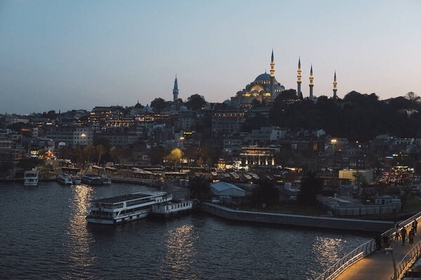 Blue mosque in the evening - lights of Istanbul city - aerial view from the bridge - traffic on the sea