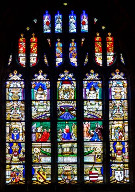 Langport, England - January 23, 2017: The interior of The Church of St Andrew in Curry Rivel, east stained glass windows clipart