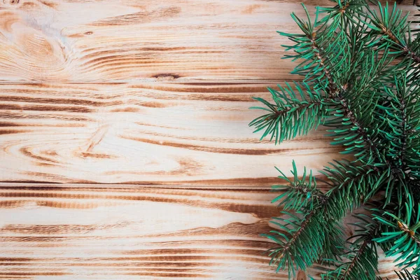 Stock image Spruce branches on a wooden background. Festive banner, postcard, invitation. New Year and Christmas concept. Copyspace.