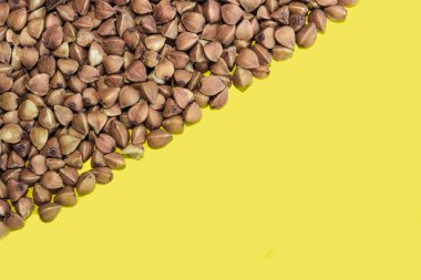 Sarı arka planda karabuğday taneleri. Metin için boşluk.