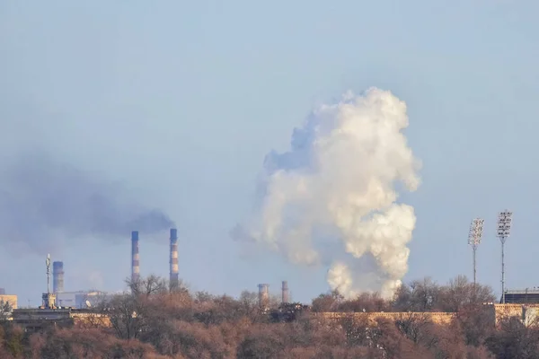 Industrial smoke emission from factory chimneys. Zaporozhye, Ukraine. The concept of the problem of protecting the environment. Air pollution.