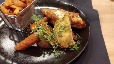 Fıstık ezmeli, sebzeli ve kızarmış patatesli gurme tavuk yemeği.