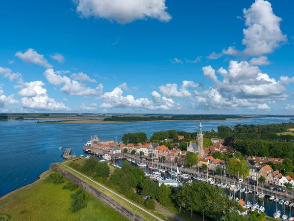 stock image Aerial view with city view of Veere with the historical city hall and the historical city fortification Campveerse Toren. In the background the Veerse Meer.  Veere is a city in the province of Zeeland in the Netherlands