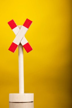 Sarı arkaplanda izole edilmiş oyuncak yol işareti