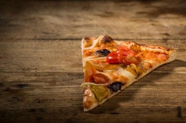 Tahta masada izole edilmiş pizza dilimi.