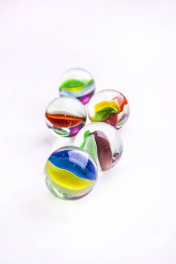 Glass marbles in the foreground. clipart