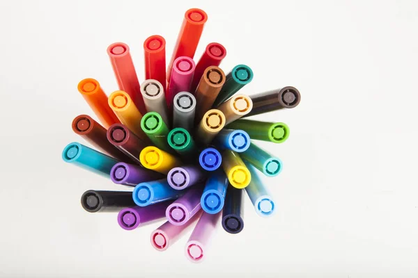 markers photographed from above on a white background