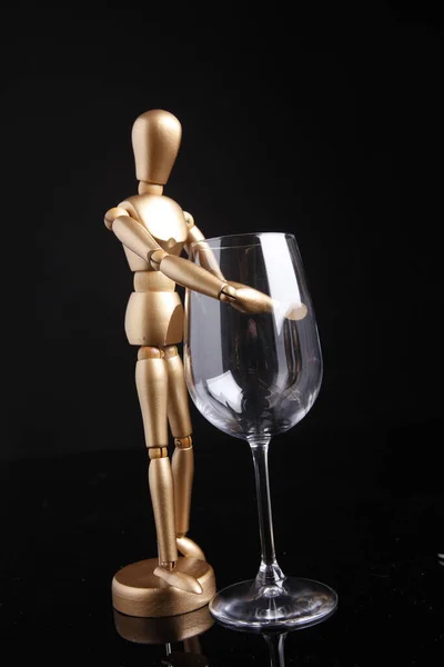 Wooden Puppet Holds Crystal Goblet Isolated Black Background — Stock Photo, Image