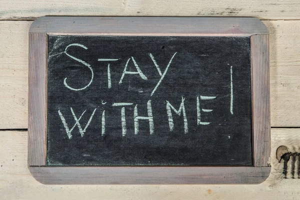 \'Stay with me\' message on a wooden board