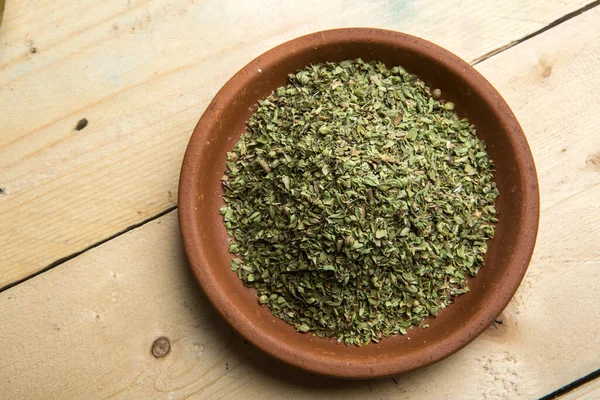 stock image chopped oregano in an earthenware bowl