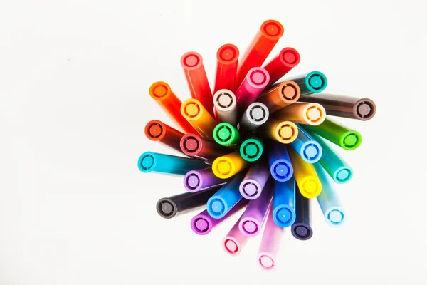 markers photographed from above on a white background