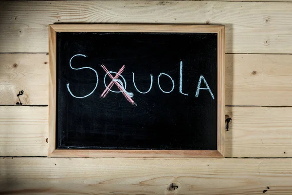 Blackboard with the writing \'Souola\' on Italian